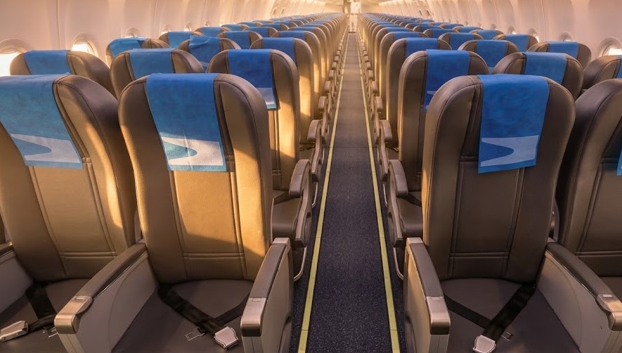 Aerolíneas Argentinas Boeing 737-800 economy cabin looking down the aisle, 3-3 seating with the airline’s blue condor headrest covers
