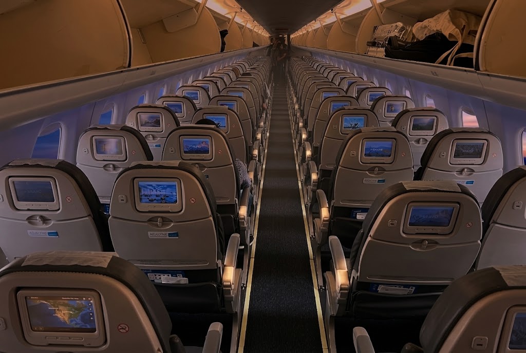 Aerolíneas Argentinas Embraer 190 cabin looking down the aisle, 2-2 seating with a seatback screen at every seat
