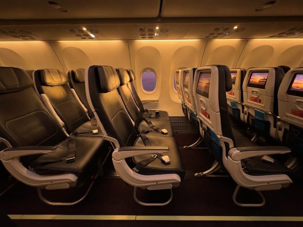 Aeroméxico Boeing 737 MAX 9 economy seats with seatback screens at every seat and a window at sunset