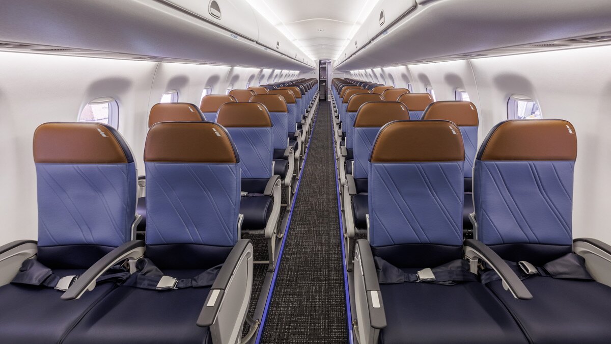 American Eagle CRJ-900 Main Cabin looking down the aisle with blue leather seats and tan headrests