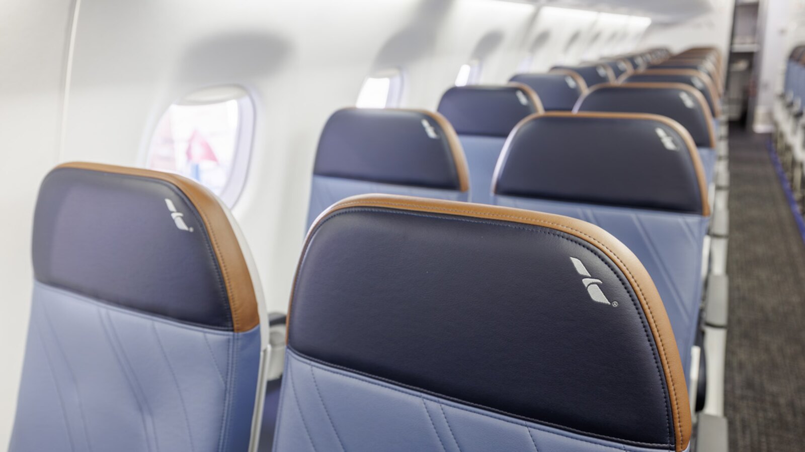 American Eagle Embraer 175 Main Cabin with blue and grey leather seats and tan headrest trim