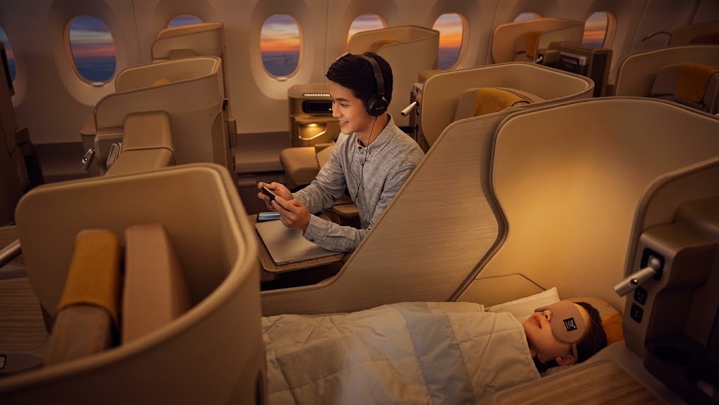 Asiana Airlines Business Smartium cabin, staggered lie-flat suites with a bed made up in the foreground