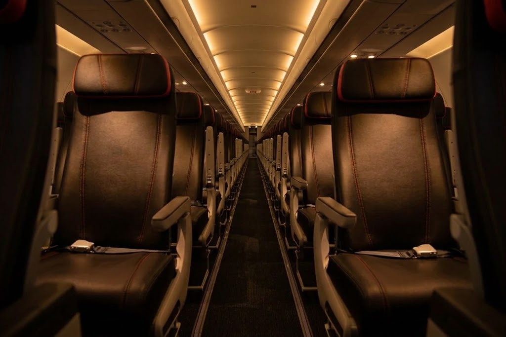 Avianca Airbus A320ceo cabin looking down the aisle, six-abreast leather seating with red stitching