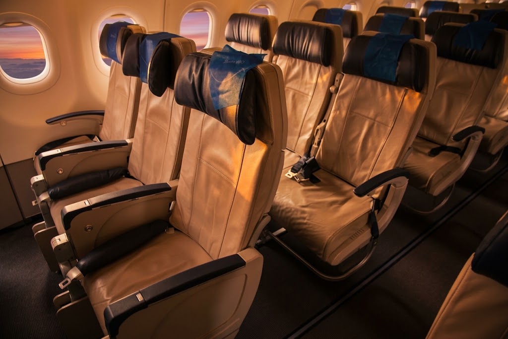 Azul Airbus A320neo economy cabin, three-by-three tan leather seating with blue headrest covers