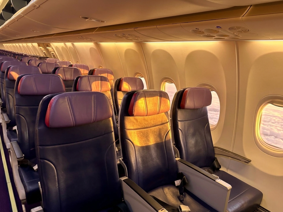 Caribbean Airlines Boeing 737 MAX 8 economy seats with red-trimmed headrests beside the windows