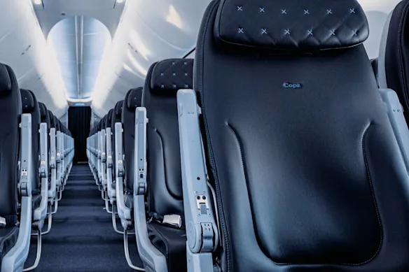 Copa Airlines Boeing 737-700 economy cabin with dark quilted leather seats