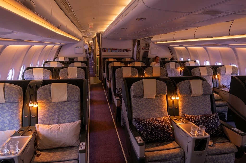 EVA Air Airbus A330-300 Premium Laurel business cabin, 2-2-2 grey patterned seats with cushions and drinks on the consoles