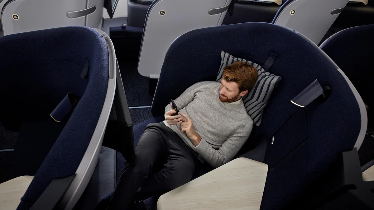 Finnair A350-900 AirLounge Business Class cabin with passenger relaxing