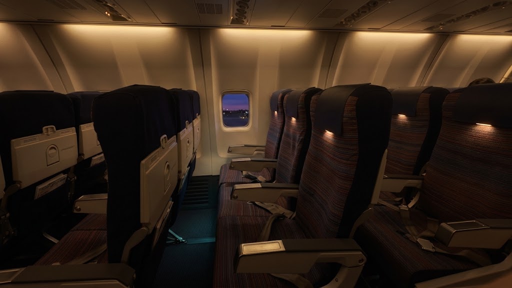 Korean Air Boeing 737-800 economy cabin, three-by-three seating with tray tables down and no seatback screens