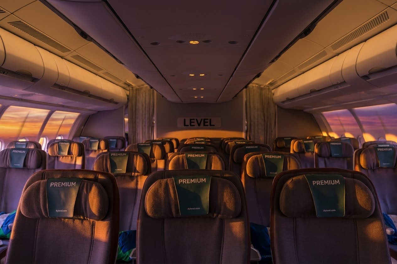 Level A330-200 premium economy cabin with rows of recliner seats and Premium headrest covers