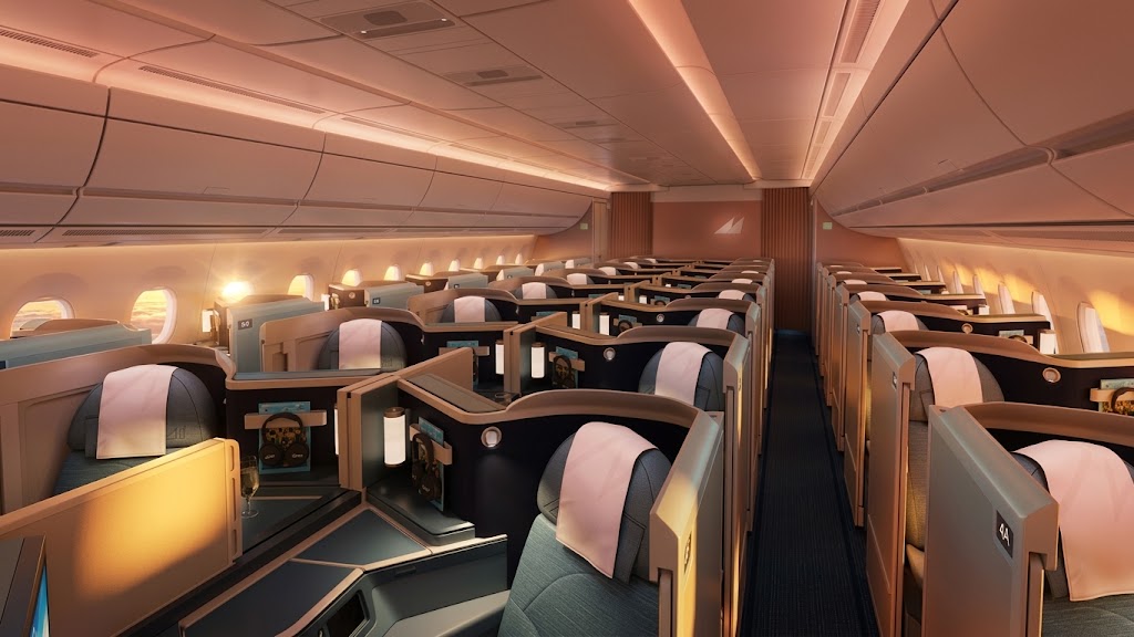 Philippine Airlines A350-1000 business cabin looking down the aisle, reverse-herringbone suites with privacy dividers under warm cabin lighting