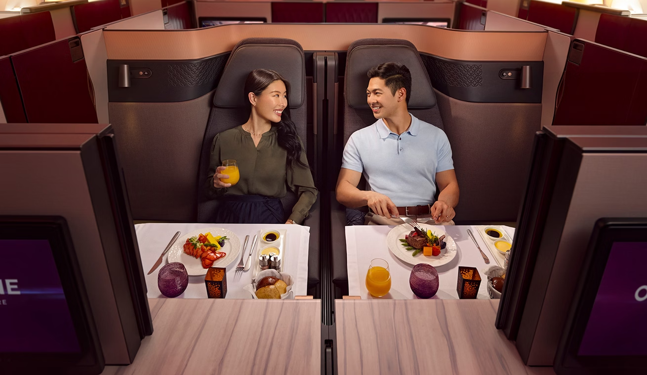 Qatar Airways A350-1000 Qsuite Business Class honeymoon suite with couple dining