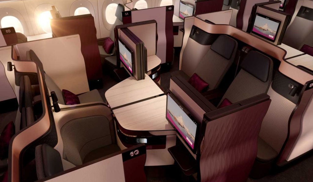 Qatar Airways Qsuite business class suite on a Boeing 777-300ER, with the sliding privacy door open