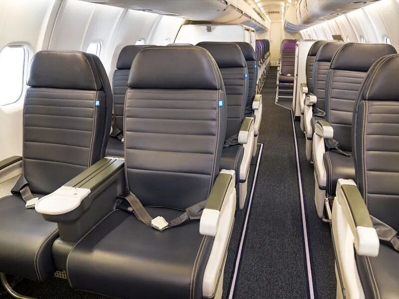 United Express CRJ-550 First Class cabin with dark blue leather recliners in a 1-2 layout