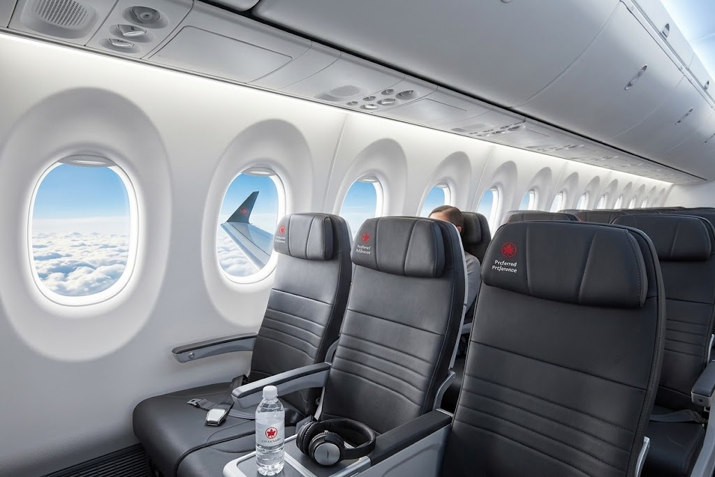 Air Canada Airbus A220-300 economy cabin with large windows and dark leather Preferred seats