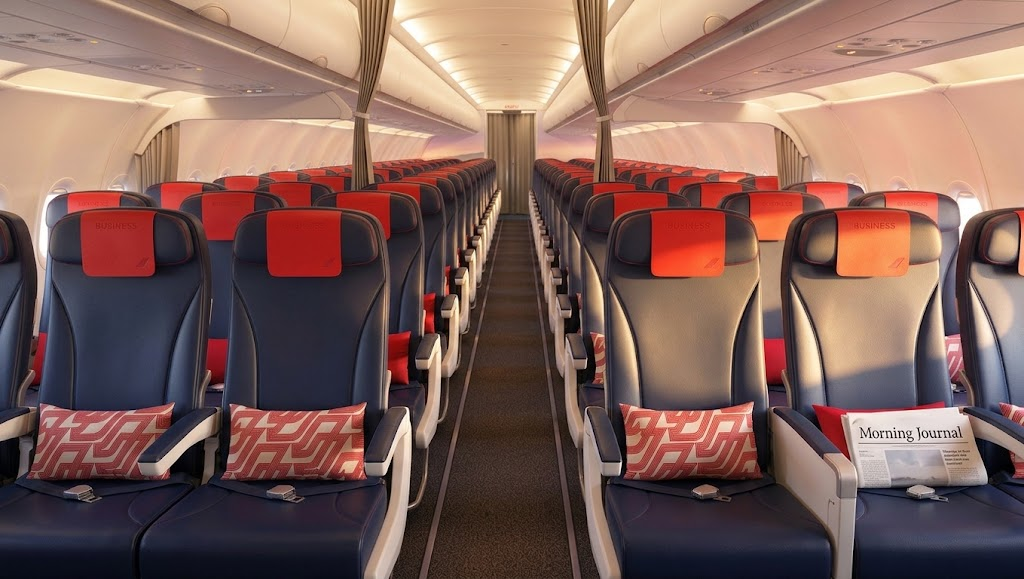 Air France Airbus A320 cabin, 3-3 seating with Business headrest covers on the forward rows and the moving curtain behind them