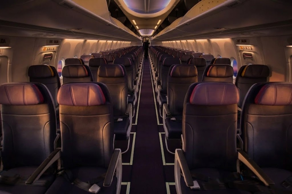 Allegiant Air Boeing 737 MAX 8 economy cabin interior in 3-3 layout with dark fixed-back slimline seats