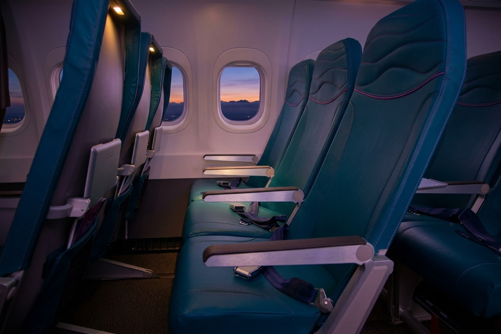 Hawaiian Airlines Boeing 717-200 Main Cabin looking down the aisle in 2-3 seating