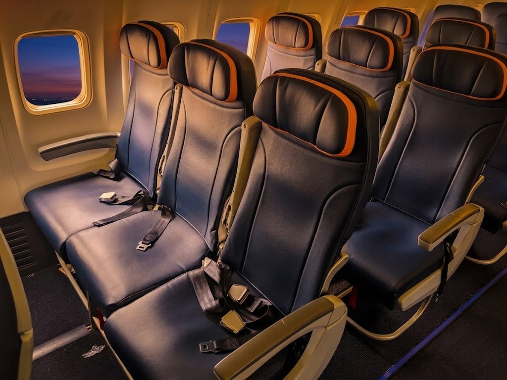 Sun Country Airlines Boeing 737-800 economy cabin window seats at dusk