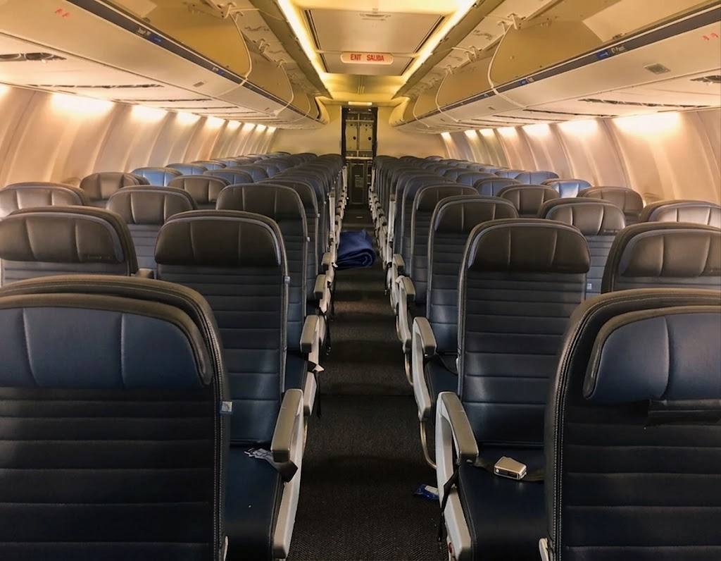 United Airlines Boeing 737-700 economy cabin in a 3-3 layout looking aft