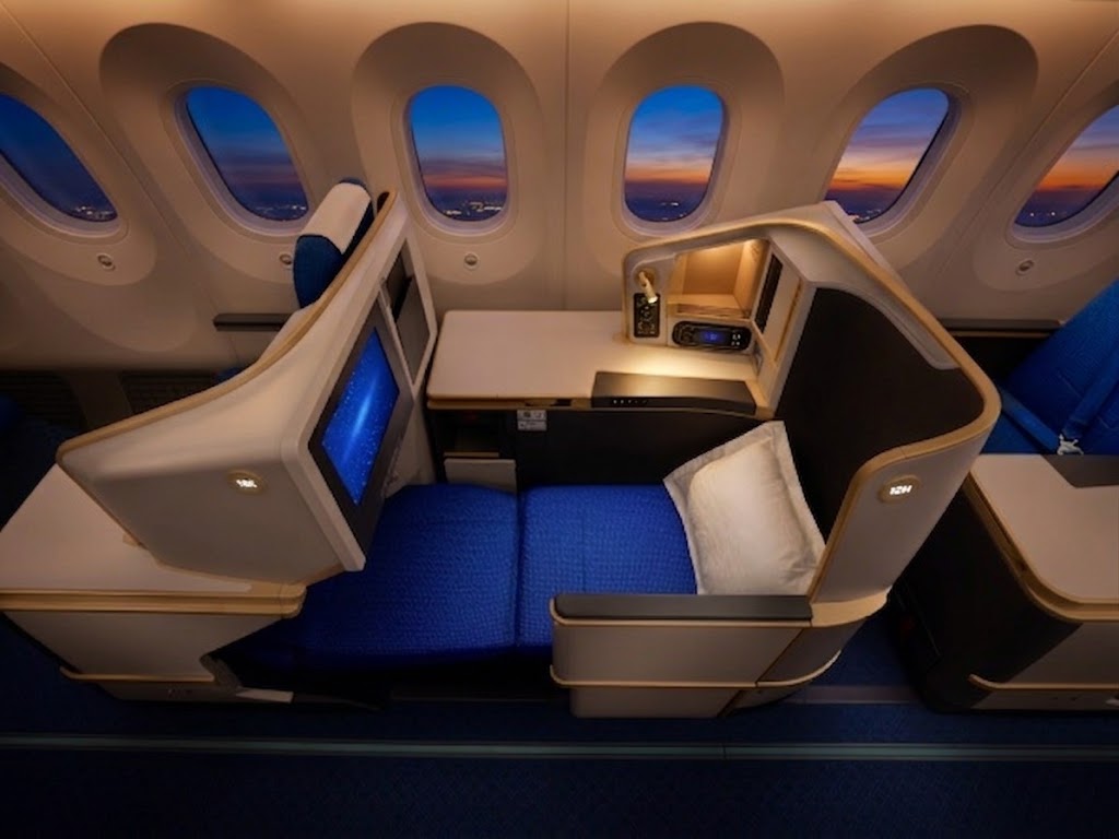 Air China Boeing 787-9 business class cabin, 2-2-2 Collins Parallel Diamond seats in blue with the bed extended
