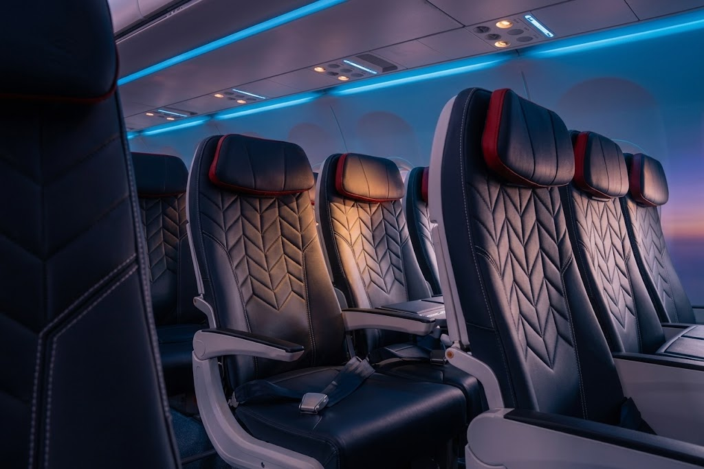 British Airways A321neo economy cabin in 3-3 with dark leather seats and red headrest accents
