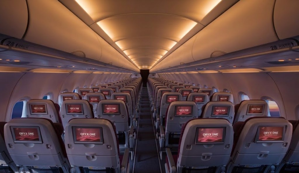 Qatar Airways A320 economy cabin looking forward, 3-3 layout with ORYX ONE seatback screens